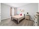 Minimalist bedroom design featuring a metal bed frame, simple furniture and neutral décor for a cozy retreat at 13423 Sw 48Th Ave, Ocala, FL 34473