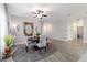 Light and airy dining room with a round table, modern chairs, and a decorative rug at 13423 Sw 48Th Ave, Ocala, FL 34473