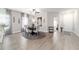 Bright dining area featuring modern furnishings, stylish decor, and wood-look flooring at 13423 Sw 48Th Ave, Ocala, FL 34473