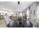 Open concept dining area showcasing modern decor, a black table, and stylish furnishings at 13423 Sw 48Th Ave, Ocala, FL 34473