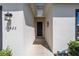 Welcoming entryway featuring a modern black front door, stylish exterior lighting, and manicured landscaping at 13423 Sw 48Th Ave, Ocala, FL 34473