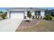 Charming single-story home featuring a well-manicured front yard, a two-car garage, and a contemporary design at 13423 Sw 48Th Ave, Ocala, FL 34473