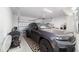 Spacious two car garage with room for storage and a sleek car with a geometric print rug at 13423 Sw 48Th Ave, Ocala, FL 34473
