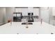 A close up on a modern kitchen island with stainless steel appliances and white cabinetry at 13423 Sw 48Th Ave, Ocala, FL 34473