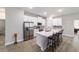 Modern kitchen features stainless steel appliances, a large island with seating, and white cabinetry at 13423 Sw 48Th Ave, Ocala, FL 34473