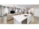 Open-concept living space featuring a modern kitchen with white cabinets, a cozy living area, and ample natural light at 13423 Sw 48Th Ave, Ocala, FL 34473