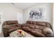 Comfortable living room with reclining sofas, accent wall art and modern décor for relaxing and unwinding at 13423 Sw 48Th Ave, Ocala, FL 34473