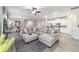 Bright and airy living room featuring an oversized sofa, recessed lighting, and an open view into the kitchen at 13423 Sw 48Th Ave, Ocala, FL 34473