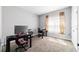 Bright home office with carpet flooring, a large window, and modern desk setup at 13423 Sw 48Th Ave, Ocala, FL 34473