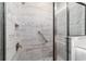 Modern shower featuring gray tile, mosaic accents, shower niche, rainfall shower head and glass doors at 13423 Sw 48Th Ave, Ocala, FL 34473