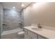 Modern bathroom features tile surround shower over tub and single sink vanity at 13588 Se 102Nd Ct, Belleview, FL 34420