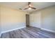 Bedroom with wood-look floors, ceiling fan, and closet at 13588 Se 102Nd Ct, Belleview, FL 34420