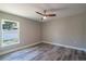 Bedroom with wood-look floors, natural light, and a ceiling fan at 13588 Se 102Nd Ct, Belleview, FL 34420