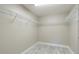 Walk-in closet featuring wire shelving and sleek gray tile flooring at 13588 Se 102Nd Ct, Belleview, FL 34420