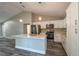 Modern kitchen featuring stainless steel appliances, an island with a sink, and sleek white cabinetry at 13588 Se 102Nd Ct, Belleview, FL 34420