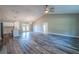 Spacious living room with vaulted ceiling, modern ceiling fan, stylish floors and open concept design at 13588 Se 102Nd Ct, Belleview, FL 34420