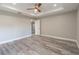 Comfortable main bedroom featuring a ceiling fan, durable floors, and plenty of natural light at 13588 Se 102Nd Ct, Belleview, FL 34420