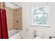 A bathroom with a shower-tub combination, a window, and a toilet at 16295 W Highway 40, Ocala, FL 34481