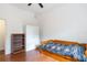 Bedroom with wood floors, trundle bed, bright window, and white walls at 16295 W Highway 40, Ocala, FL 34481