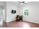 Bright bedroom with a ceiling fan, TV, and small desk area with a window view at 16295 W Highway 40, Ocala, FL 34481