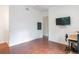 Spacious room featuring laminate floors, a tv, and a small desk with a chair at 16295 W Highway 40, Ocala, FL 34481