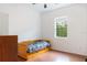 Bright bedroom featuring hardwood floors and a large window with a treed view at 16295 W Highway 40, Ocala, FL 34481