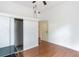 This bedroom features sleek wood floors, a ceiling fan, and closet space for optimal storage at 16295 W Highway 40, Ocala, FL 34481