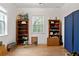 An empty bedroom space with a hardwood floor, two bookcases and a window at 16295 W Highway 40, Ocala, FL 34481