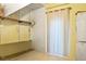 A closet with shelving, curtain, and a stacked washer and dryer at 16295 W Highway 40, Ocala, FL 34481