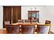 Traditional dining room with wood table, matching chairs, and a glass-front display cabinet at 16295 W Highway 40, Ocala, FL 34481