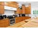 Spacious kitchen featuring wooden cabinets, stainless steel appliances, and a functional design for cooking at 16295 W Highway 40, Ocala, FL 34481