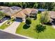 A beautiful home featuring a screened-in lanai, an attached garage, a green lawn, and a charming tree at 16299 Sw 14Th Avenue Rd, Ocala, FL 34473