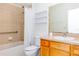 Cozy bathroom with tiled shower and bathtub combination, vanity with sink, and framed mirror at 16299 Sw 14Th Avenue Rd, Ocala, FL 34473