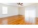 Bright bedroom featuring laminate floors, ceiling fan, and sliding doors at 16299 Sw 14Th Avenue Rd, Ocala, FL 34473