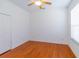 Bright bedroom featuring hardwood floors, a ceiling fan, and natural light from a window at 16299 Sw 14Th Avenue Rd, Ocala, FL 34473