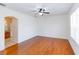 Spacious bedroom with wood floors, ceiling fan, window, and ensuite bathroom at 16299 Sw 14Th Avenue Rd, Ocala, FL 34473