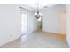 Dining room features tile flooring, modern chandelier, and sliding glass door at 16299 Sw 14Th Avenue Rd, Ocala, FL 34473