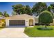 Charming single-story home featuring a well-maintained lawn, attached garage and manicured landscaping at 16299 Sw 14Th Avenue Rd, Ocala, FL 34473
