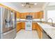 Well-lit kitchen boasts stainless appliances, granite counters, and light wood cabinetry at 16299 Sw 14Th Avenue Rd, Ocala, FL 34473