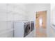Well-organized laundry room with shelves and modern washer and dryer units at 16299 Sw 14Th Avenue Rd, Ocala, FL 34473