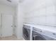 Modern laundry room with organized shelving and large capacity washer and dryer at 16299 Sw 14Th Avenue Rd, Ocala, FL 34473