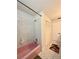 Bathroom featuring pink bathtub and shower, tile floor, and a storage closet at 1711 Sw 63Rd St Rd, Ocala, FL 34476