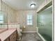 Bathroom featuring a walk-in shower and patterned wall paper at 1711 Sw 63Rd St Rd, Ocala, FL 34476