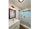 Updated bathroom features a glass enclosed tiled shower, modern vanity, and contemporary lighting at 1711 Sw 63Rd St Rd, Ocala, FL 34476
