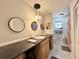 Bright bathroom featuring a long counter with sink, vanity, decorative mirrors, and a shower at 1711 Sw 63Rd St Rd, Ocala, FL 34476