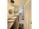 Bathroom featuring double sinks, storage cabinets, and a shower with decorative pink curtain at 1711 Sw 63Rd St Rd, Ocala, FL 34476