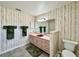 Bathroom with shower, pink vanity with dark red sink, and patterned wallpaper at 1711 Sw 63Rd St Rd, Ocala, FL 34476