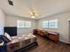 Bedroom featuring two windows with blinds and desks, a ceiling fan, and hardwood flooring at 1711 Sw 63Rd St Rd, Ocala, FL 34476