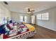 Spacious bedroom with two beds, ample natural light, ceiling fan, and access to a balcony at 1711 Sw 63Rd St Rd, Ocala, FL 34476