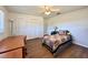 Cozy bedroom featuring hardwood floors, a ceiling fan, and a closet with shuttered doors at 1711 Sw 63Rd St Rd, Ocala, FL 34476